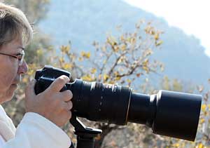 Photographer using Nikon digital SLR and telephoto lens