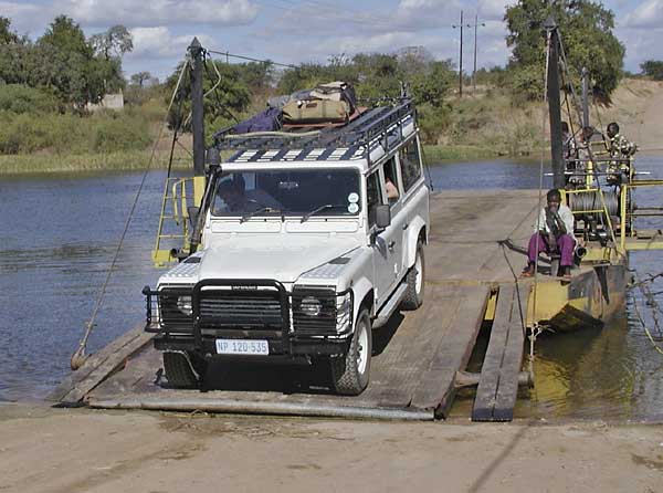 Crossing ferry in Africa in Land Rover Defender