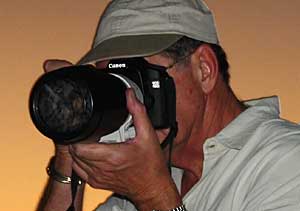 Photographer using Canon digital SLR and telephoto lens